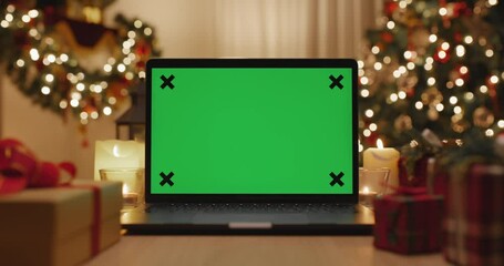 Merry Xmas eve wishing happy joy in blank laptop live video call, watching webcam, web page frame in good warm time winter season with gift on desk table and gold color tree light at night cozy home. - Powered by Adobe