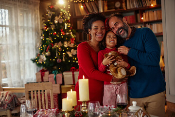 Happy family of three at Christmas table