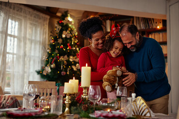 Cheerful family celebrating Christmas at home