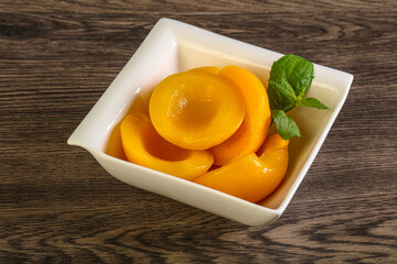 Sweet ripe canned peaches with mint