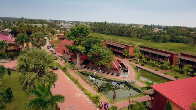 Cinematic drone shot of Aqua Safari Resort garden and exterior, in Ghana, West Africa