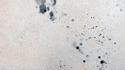 Concrete surface with black paint stains, top view