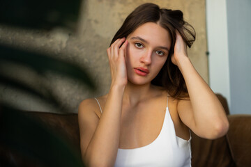 Fototapeta premium Close-up portrait of a beautiful young caucasian woman with natural brown hair.