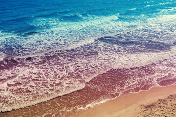 Sea surf on a sandy beach