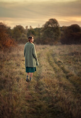 Photo of a beautiful village girl in a meadow.