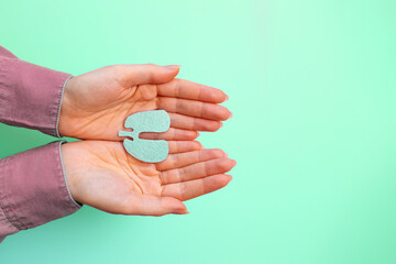 Female's hands hold the cut-out silhouette of the lungs. Flat lay. Turquoise background. Copy...
