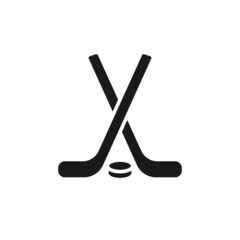 Isolated black icon of hockey stick and puck on white background. Silhouette of ice hockey icon. Logo flat design. Winter sport equipment.