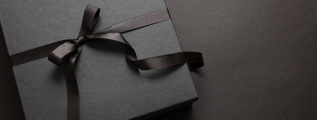 Black Friday sale concept, Gift box with ribbon bow on black background
