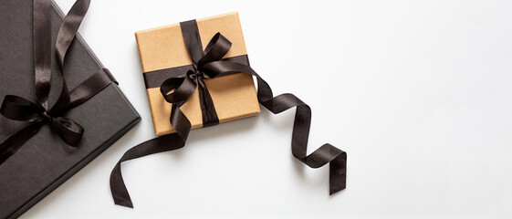 Black Friday sale concept, Gift boxes with black ribbons on white background, top view.