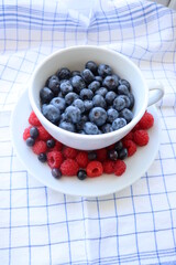 A cup of fresh berries in the morning light