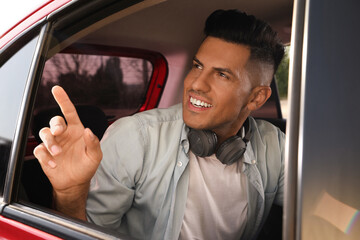 Man looking out of taxi window outdoors