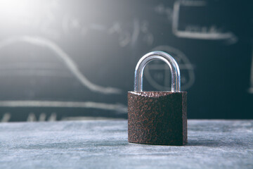 lock on the table on the background of the blackboard