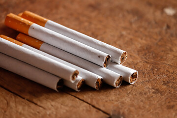 Multiple Cigarette on wooden table with selective focus,a pack of cigarettes,a close-up of a...