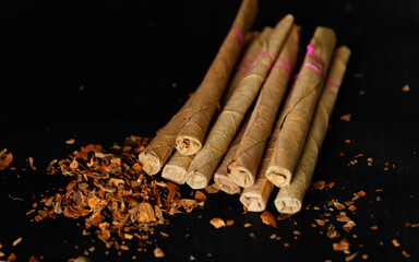 Indian most popular cigare locally call bidi making with tobacco products,Indian sigar bidi on wooden table,dangerous and toxic habit