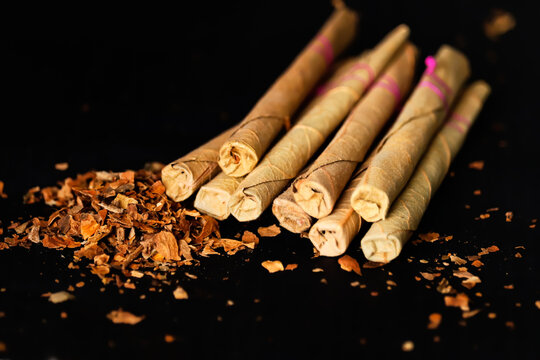 Indian most popular cigare locally call bidi making with tobacco products,Indian sigar bidi on wooden table,dangerous and toxic habit