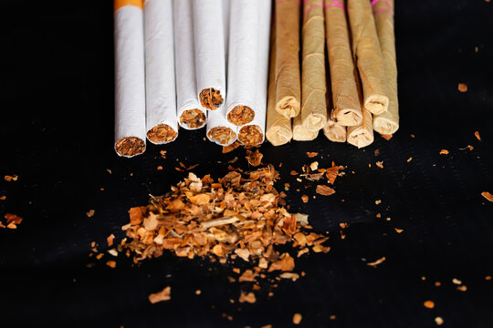 Tobacco bidi and cigarettes on black background with selective focus,Bidi,Cigarette Locally called a Bidi, tobacco and bidi,dry tabacco