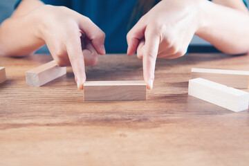 young woman holding wooden rectangles