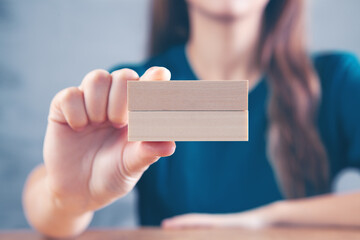 young woman holding wooden rectangles