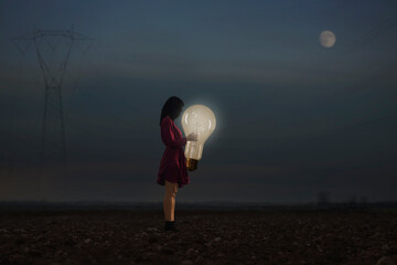 woman embraces one of her creative idea lighting up the night, power concept