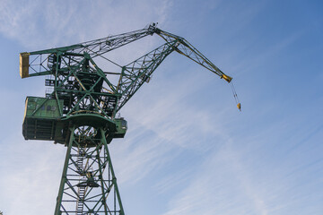 Naklejka premium Gdansk, Poland. 2021 Old shipbuilding company. Cranes for the construction of boats. On the Sunset.