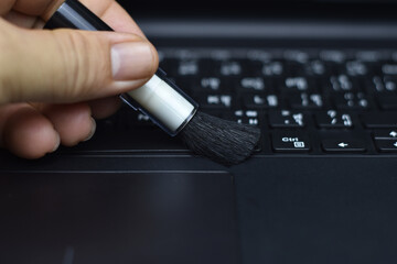 Cleaning the keyboard with a dust brush