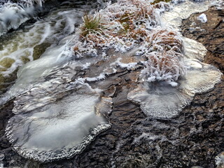 Fast river with ice in late autumn