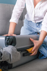 Travel. Online travel plans with Covid passport and Covid test. Traveling after quarantine, lockdown, covid 19. Staycation.local travel new normal.Girl packs baggage in suitcase and travel documents