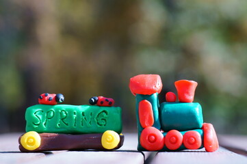 A toy train with fairy-tale characters and the inscription spring.