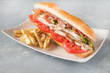 Sandwich Serranito typical in Andalusia with ham, green pepper and grilled pork loin