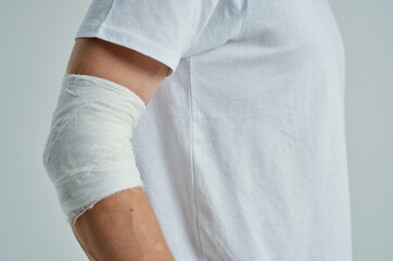 sick man in a white T-shirt with a bandaged hand hospital medicine