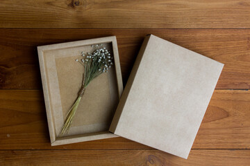 Vintage box with white flower on wooden table. 