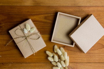 Vintage gift box with flowers on wooden table. 