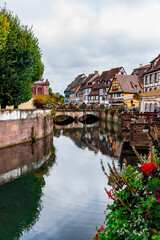Fototapeta na wymiar Colorful historic houses by the lake and bridge in Colmar France