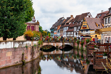 Colorful historic houses by the lake and bridge in Colmar France