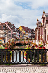 Colorful historic houses by the lake and bridge in Colmar France