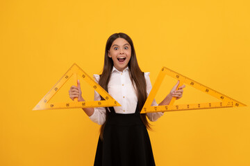 surprised kid in school uniform hold mathematics triangle for measuring, knowledge