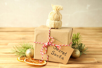 Secret Santa and Christmas composition on wooden table