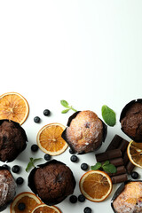 Concept of delicious food with chocolate muffins on white background