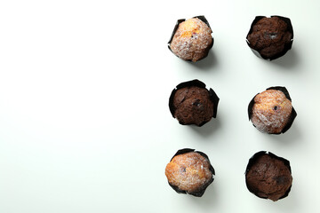 Chocolate muffins on white background, space for text