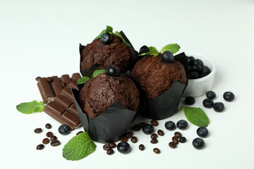 Concept of delicious food with chocolate muffins on white background
