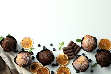 Concept of delicious food with chocolate muffins on white background