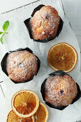 Concept of delicious food with chocolate muffins on white wooden table