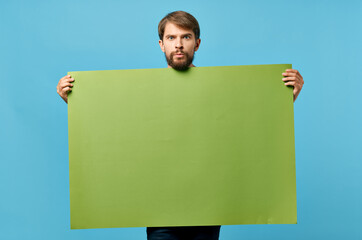 Cheerful man green paper in the hands of marketing isolated background