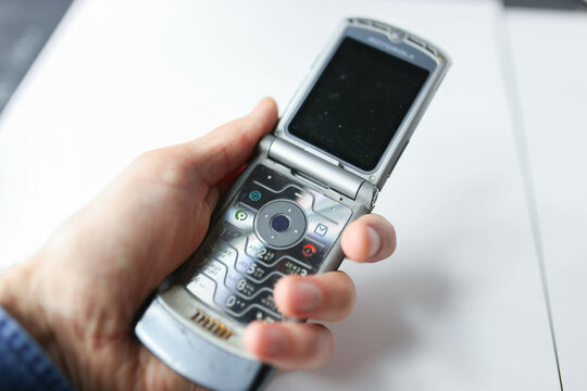 Minsk, Belarus - November 22, 2019: Foldable Motorola RAZR V3 mobile phone on a white background, slim flagship phone 2004.	
