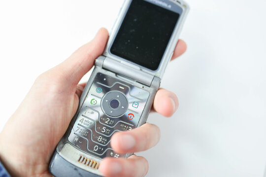 Minsk, Belarus - November 22, 2019: Foldable Motorola RAZR V3 mobile phone on a white background, slim flagship phone 2004.	