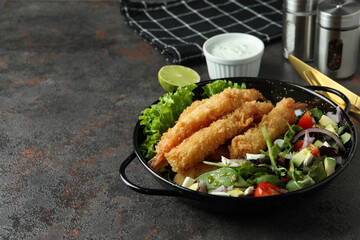 Сoncept of tasty food with deep-fried shrimp on dark table