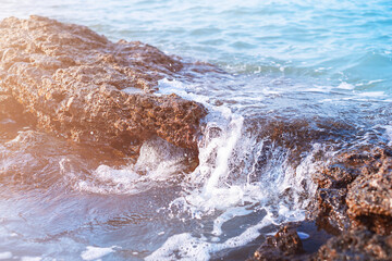 Naklejka premium Sea water flows over rocks in the ocean.