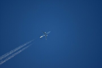 jet plane for passengers on the blue sky. domestic transport aircraft polluting with smoke in the blue sky