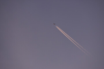 jet plane for passengers on the blue sky. domestic transport aircraft polluting with smoke in the blue sky