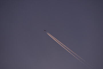 jet plane for passengers on the blue sky. domestic transport aircraft polluting with smoke in the blue sky